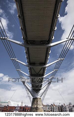 A low angle view underneath the Millennium Bridge from the River Thames bank in Bankside; London, England View Large Photo Image Stock Photograph - A low angle view underneath the Millennium Bridge from the River Thames bank in Bankside; London, England. Fotosearch