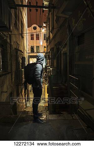 A male traveler looking down a narrow street; Xiamen, Fujian, China View Large Photo Image Picture - A male traveler looking down a narrow street; Xiamen, Fujian, China. Fotosearch