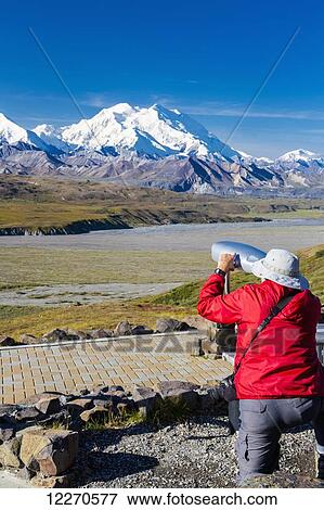 A male visitor views Mt. McKinley through the park provided scope at Eielson Visitor Center in Denali National Park, Interior Alaska, Summer, USA. View Large Photo Image Stock Photo - A male visitor views Mt. McKinley through the park provided scope at Eielson Visitor Center in Denali National Park, Interior Alaska, Summer, USA.. Fotosearch