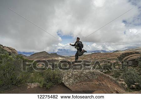 A man jumps on a rock looking out over the beautiful landscape of Toro Toro National Park; Bolivia View Large Photo Image Stock Image - A man jumps on a rock looking out over the beautiful landscape of Toro Toro National Park; Bolivia. Fotosearch