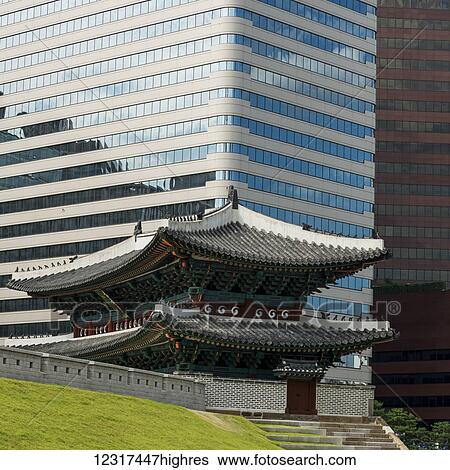 Stock Photograph - A modern office building and building of traditional Korean architecture; Seoul, South Korea. Fotosearch