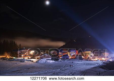 Stock Photograph - A night burn at the ski resort's annual hot air balloon festival; Filzmoos, Austria. Fotosearch