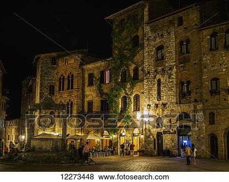 A nighttime view of the piazza in San Gimingano, a small walled Tuscan town in Italy; San Gimignano, Siena, Italy View Large Photo Image Stock Photo - A nighttime view of the piazza in San Gimingano, a small walled Tuscan town in Italy; San Gimignano, Siena, Italy. Fotosearch