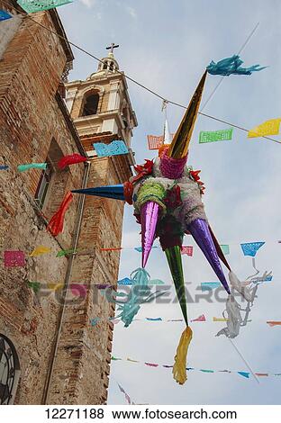 Stock Photo - A pinata hangs outside the the Church of Our Lady of Guadalupe during the feast of the Virgin of Guadalupe; Puerto Vallerta, Mexico. Fotosearch