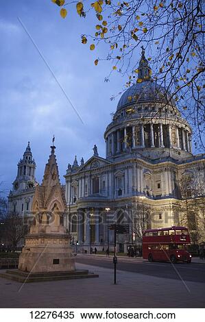 A red London Route Master double-decker bus passes St Paul's Cathedral at dusk, with the St Lawrence Jewry Memorial Fountain in the foreground; London, England View Large Photo Image Stock Photography - A red London Route Master double-decker bus passes St Paul's Cathedral at dusk, with the St Lawrence Jewry Memorial Fountain in the foreground; London, England. Fotosearch