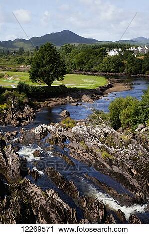 A river flowing across rock and a lush landscape with houses; Sneem, County Kerry, Ireland View Large Photo Image Stock Image - A river flowing across rock and a lush landscape with houses; Sneem, County Kerry, Ireland. Fotosearch