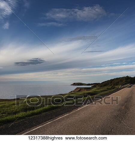 Stock Photograph - A road along the Atlantic coastline, Cape Breton Island; Nova Scotia, Canada. Fotosearch
