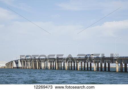 Stock Image - A road bridge with traffic going over water, near Cadiz; Andalusia, Spain. Fotosearch