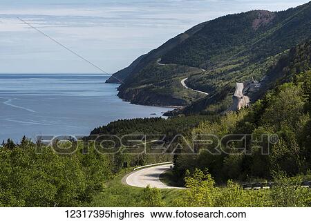 Stock Photograph - A road winding along the coastline, Cape Breton Highlands National Park; Petit Etang, Nova Scotia, Canada. Fotosearch