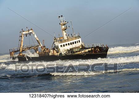 A rusty sunken abandoned ship in the waves of Atlantic Ocean on the Namibian coast (Zeila Shipwreck); Namibia View Large Photo Image Stock Photograph - A rusty sunken abandoned ship in the waves of Atlantic Ocean on the Namibian coast (Zeila Shipwreck); Namibia. Fotosearch