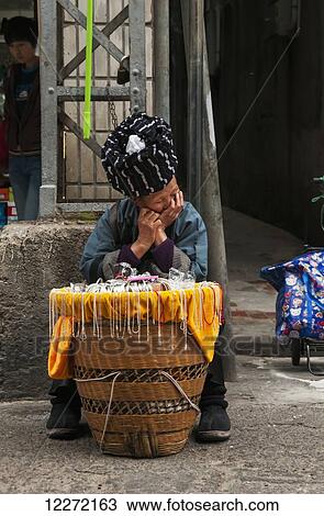 A senior woman from an ethnic minority selling jewelry in Bashi Market and fell asleep at her table; Xiamen, Fujian Province, China View Large Photo Image Stock Image - A senior woman from an ethnic minority selling jewelry in Bashi Market and fell asleep at her table; Xiamen, Fujian Province, China. Fotosearch