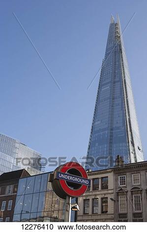 A sign for the London Underground at London Bridge station with The Shard by Renzo Piano rising above historical buildings on Borough High Street; London, England View Large Photo Image Stock Image - A sign for the London Underground at London Bridge station with The Shard by Renzo Piano rising above historical buildings on Borough High Street; London, England. Fotosearch