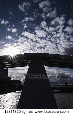 Stock Photograph - A silhouetted view from Millennium Bridge against a dramatic spring sky; London, England. Fotosearch