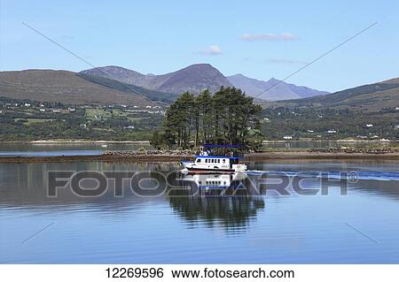 Stock Photograph - A tour boat in Kenmare Bay; Kenmare, County Kerry, Ireland. Fotosearch