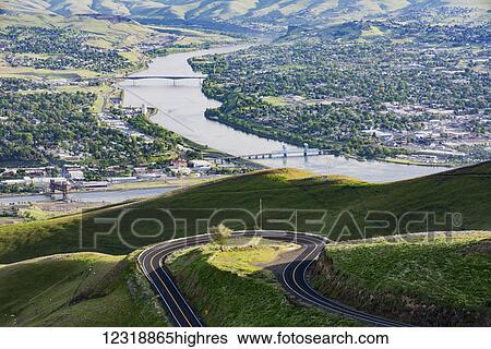 Stock Photograph - A view from near the top of the Spiral Highway looking back at just one of many hairpin turns, with Lewiston Idaho on the left and Clarkston, Washington on the right, separated by the Snake River at the confluence with the Clearwater River;.... Fotosearch