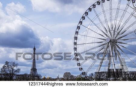 A view of the Big Wheel and the Eiffel Tower; Paris, France View Large Photo Image Stock Photograph - A view of the Big Wheel and the Eiffel Tower; Paris, France. Fotosearch