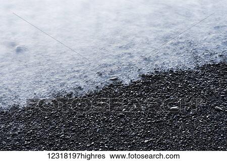A wave breaks on a pebble beach; Cannon Beach, Oregon, United States of America View Large Photo Image Stock Photograph - A wave breaks on a pebble beach; Cannon Beach, Oregon, United States of America. Fotosearch