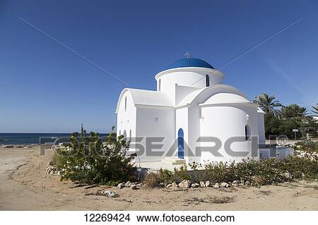 Picture - A white church building on a beach along the coast; Geroskipou, Cyprus. Fotosearch