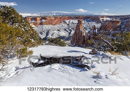 A woman makes a snow angel in the snow in front of the 450 foot high sandstone Independence Monument in the Colorado National Monument; Colorado, United States of America View Large Photo Image Stock Photograph - A woman makes a snow angel in the snow in front of the 450 foot high sandstone Independence Monument in the Colorado National Monument; Colorado, United States of America. Fotosearch