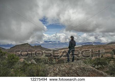 A woman stands on a rock looking out over the beautiful landscape of Toro Toro National Park; Bolivia View Large Photo Image Picture - A woman stands on a rock looking out over the beautiful landscape of Toro Toro National Park; Bolivia. Fotosearch