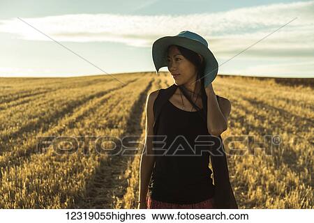 A young Asian woman walking in a golden wheat field; Madrid, Spain View Large Photo Image Stock Photograph - A young Asian woman walking in a golden wheat field; Madrid, Spain. Fotosearch