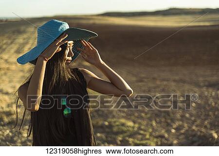 A young Asian woman walking in a golden wheat field; Madrid, Spain View Large Photo Image Stock Photograph - A young Asian woman walking in a golden wheat field; Madrid, Spain. Fotosearch