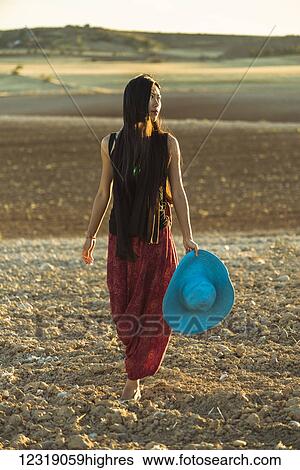 A young Asian woman walking in a golden wheat field; Madrid, Spain View Large Photo Image Stock Photograph - A young Asian woman walking in a golden wheat field; Madrid, Spain. Fotosearch