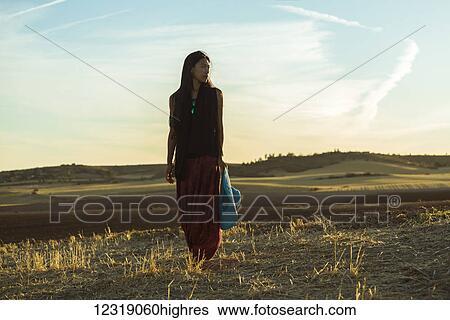A young Asian woman walking in a golden wheat field; Madrid, Spain View Large Photo Image Stock Photograph - A young Asian woman walking in a golden wheat field; Madrid, Spain. Fotosearch