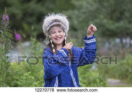 A young Inupiat tween girl in a traditional Eskimo Kuspuk and native headdress dancing, Hatcher Pass, Palmer, Southcentral, Summer View Large Photo Image Stock Photo - A young Inupiat tween girl in a traditional Eskimo Kuspuk and native headdress dancing, Hatcher Pass, Palmer, Southcentral, Summer. Fotosearch