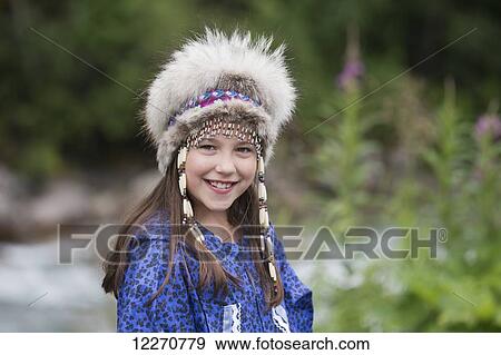 A young Inupiat tween girl in a traditional Eskimo Kuspuk and native headdress, Hatcher Pass, Palmer, Southcentral, Summer View Large Photo Image Stock Photo - A young Inupiat tween girl in a traditional Eskimo Kuspuk and native headdress, Hatcher Pass, Palmer, Southcentral, Summer. Fotosearch