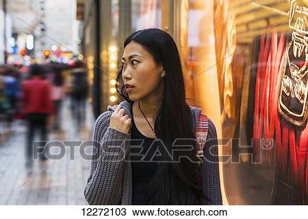 A young woman shopping along the street, Kowloon; Hong Kong, China View Large Photo Image Stock Image - A young woman shopping along the street, Kowloon; Hong Kong, China. Fotosearch