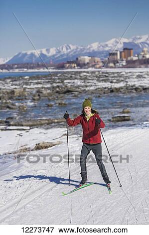 A young woman skate skiing down the Tony Knowles Coastal Trail, Anchorage, Southcentral Alaska, USA. View Large Photo Image Stock Photo - A young woman skate skiing down the Tony Knowles Coastal Trail, Anchorage, Southcentral Alaska, USA.. Fotosearch