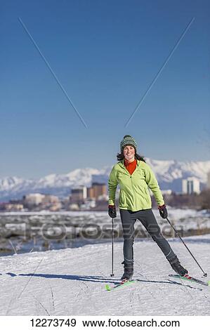 A young woman skate skiing down the Tony Knowles Coastal Trail, Anchorage, Southcentral Alaska, USA. View Large Photo Image Stock Photo - A young woman skate skiing down the Tony Knowles Coastal Trail, Anchorage, Southcentral Alaska, USA.. Fotosearch