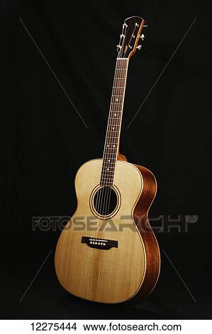Picture - Acoustic guitar on a black background; United States of America. Fotosearch