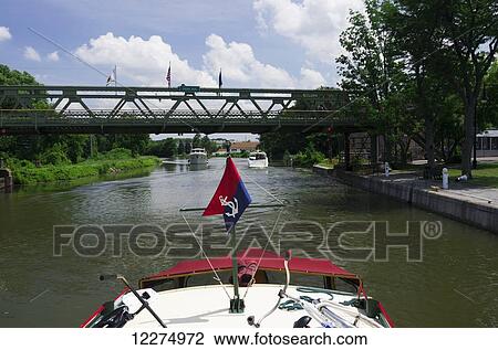 Stock Image - Adams Bridge and two private yachts from roof of charter boat; Brockport, New York, United States of America. Fotosearch