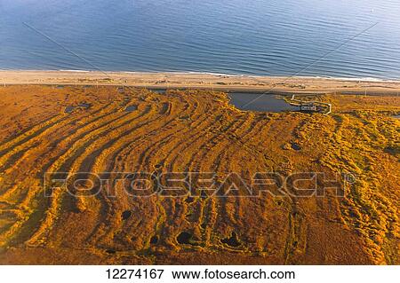 Stock Photo - Aerial view of gold dredged land and tailings along the Bearing Sea, Nome, Arctic Alaska, USA, Fall. Fotosearch