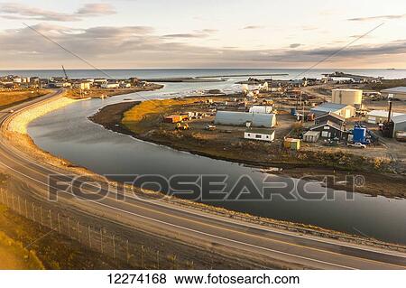 Stock Photo - Aerial view of the Nome breakwater and harbor during sunset with the Bearing Sea in the distance, Nome, Arctic Alaska, USA, Fall. Fotosearch