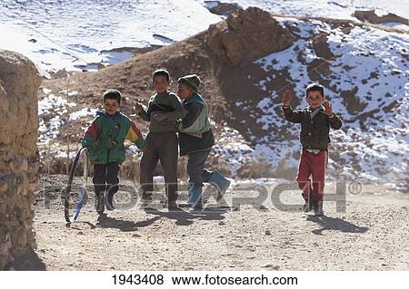 Stock Photo - Afghan Boys Playing Along A Road In The Shahidan Valley, Bamian Province, Afghanistan. Fotosearch
