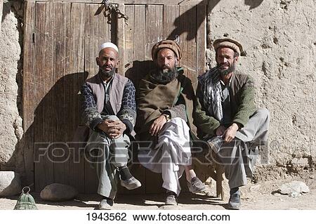 Afghan Men Sitting By A Door In Chahar Deh-Ye Ghowr Band, Parwan Province, Afghanistan View Large Photo Image Stock Image - Afghan Men Sitting By A Door In Chahar Deh-Ye Ghowr Band, Parwan Province, Afghanistan. Fotosearch