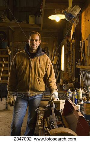 Agriculture - A farmer poses in his farm workshop / Iowa, USA. View Large Photo Image Stock Image - Agriculture - A farmer poses in his farm workshop / Iowa, USA.. Fotosearch
