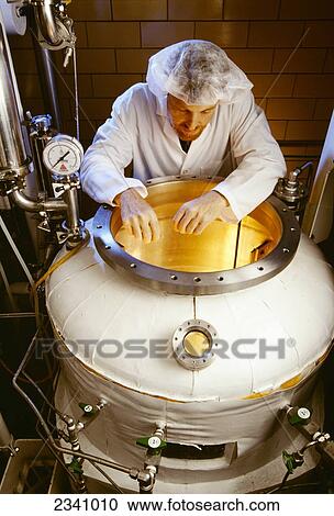 Agriculture - A technician examines an 800 liter fermentor used for bacterial culture growth in the animal vaccine industry. View Large Photo Image Stock Image - Agriculture - A technician examines an 800 liter fermentor used for bacterial culture growth in the animal vaccine industry.. Fotosearch