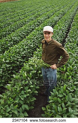 Agriculture - A young farmer poses in his family View Large Photo Image Picture - Agriculture - A young farmer poses in his family. Fotosearch