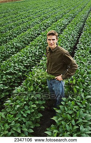 Stock Photograph - Agriculture - A young farmer poses in his family. Fotosearch