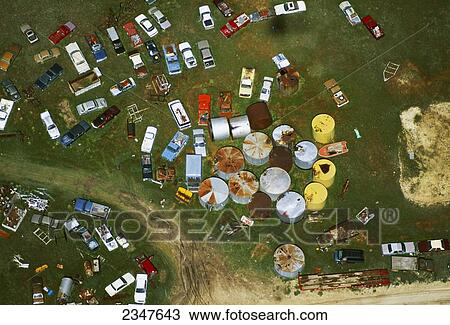 Agriculture - Aerial view of a farm junkyard with old cars, tanks and other miscellaneous farm junk / near Hays, Kansas, USA. View Large Photo Image Stock Image - Agriculture - Aerial view of a farm junkyard with old cars, tanks and other miscellaneous farm junk / near Hays, Kansas, USA.. Fotosearch