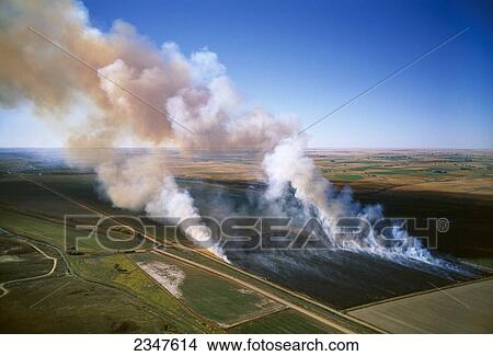 Picture - Agriculture - Aerial view of a field of grain stubble being burned / near Lamar, Colorado, USA.. Fotosearch