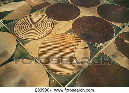 Stock Photo - Agriculture - Aerial view of fallow center pivot irrigated circular agricultural fields / near Circle, Texas, USA.. Fotosearch