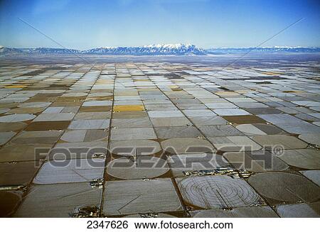Agriculture - Aerial view of fallow center pivot irrigated circular agricultural fields in Winter, with the Rocky Mountains in the background / San Luis Valley, Colorado, USA. View Large Photo Image Stock Photograph - Agriculture - Aerial view of fallow center pivot irrigated circular agricultural fields in Winter, with the Rocky Mountains in the background / San Luis Valley, Colorado, USA.. Fotosearch