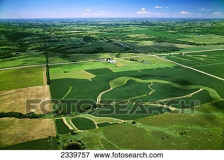 Agriculture - Aerial view of rolling agricultural land, the foreground field shows grassy waterways that drain rainwater from the field / near Colfax, Iowa, USA. View Large Photo Image Stock Photo - Agriculture - Aerial view of rolling agricultural land, the foreground field shows grassy waterways that drain rainwater from the field / near Colfax, Iowa, USA.. Fotosearch