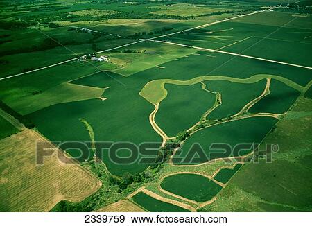 Agriculture - Aerial view of rolling agricultural land, the foreground field shows grassy waterways that drain rainwater from the field / near Colfax, Iowa, USA. View Large Photo Image Stock Photo - Agriculture - Aerial view of rolling agricultural land, the foreground field shows grassy waterways that drain rainwater from the field / near Colfax, Iowa, USA.. Fotosearch