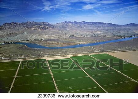 Agriculture - Aerial view of rectangular agricultural fields, with the Colorado River flowing nearby and mountains in the background / near Parker, Arizona, USA. View Large Photo Image Stock Photograph - Agriculture - Aerial view of rectangular agricultural fields, with the Colorado River flowing nearby and mountains in the background / near Parker, Arizona, USA.. Fotosearch